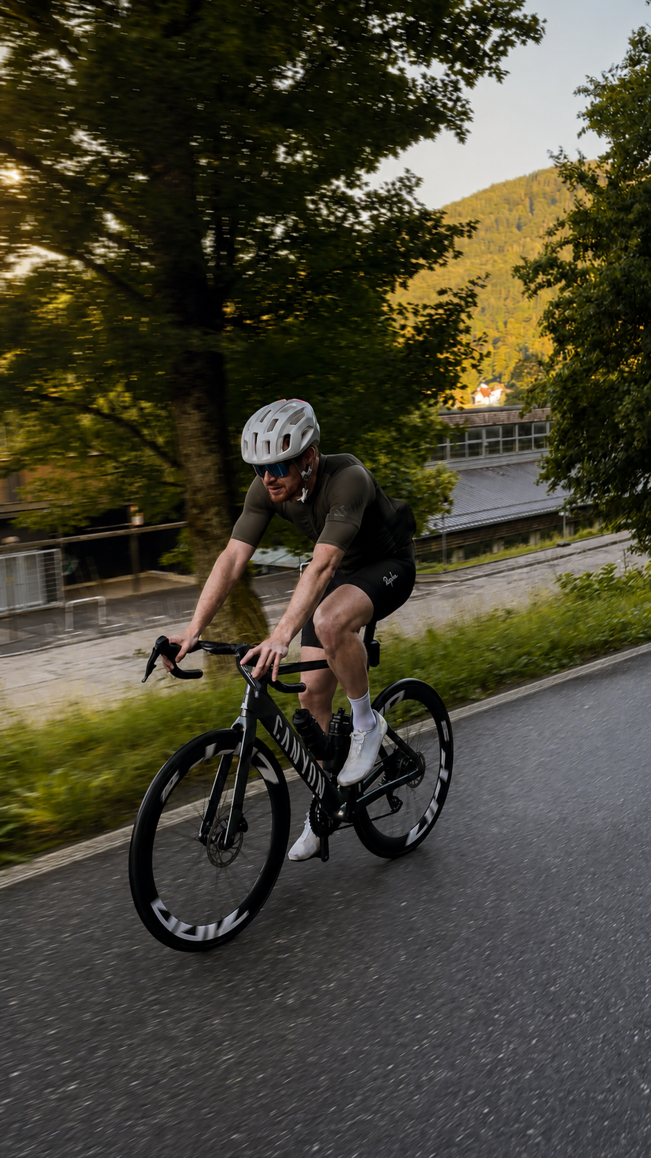 Chris riding uphill on his road bike